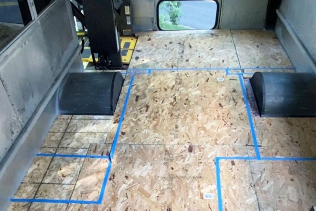 Sassy Bus floor plan marked with blue tape